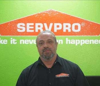   A man wearing SRVPRO attire smiling.