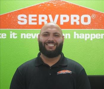 A young man in a black SERVPRO polo.