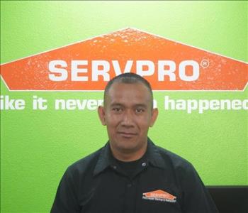 A young woman in SERVPRO attire smiling