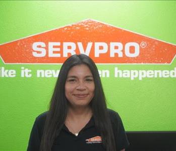 A young woman in SERVPRO attire smiling